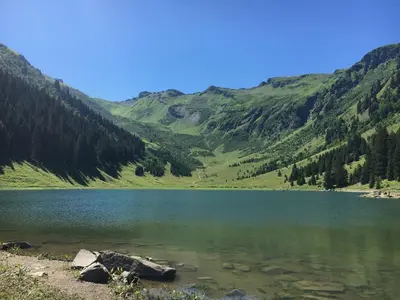 a lake in the middle of a mountain at Chalet*** au pied d'une prairie face à la montagne in Sixt