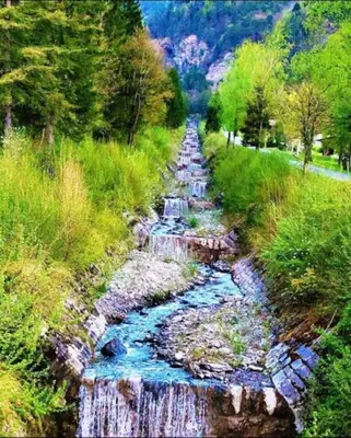 a painting of a river in a field at les loges de l'Arpenaz in Magland