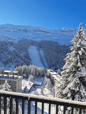 a view from the balcony of a resort in the snow at La spatule in Flaine