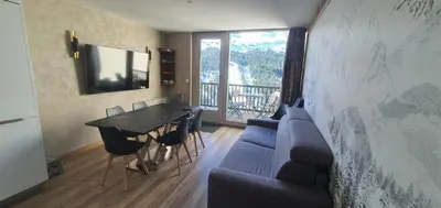 a living room with a couch and a table at La spatule in Flaine