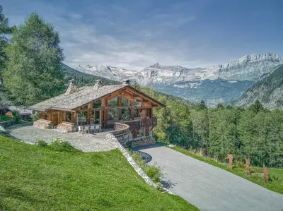 a log cabin in the mountains covered in snow at Chalet Castor in Les Houches