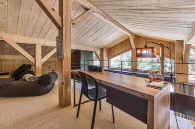 a room with a desk and chairs in a building at Chalet Castor in Les Houches