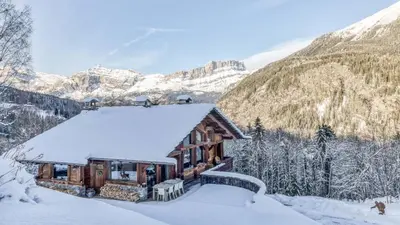 a log home with a view of the mountains at Chalet Castor in Les Houches
