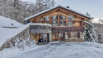 a large log cabin with a large window at Chalet Castor in Les Houches