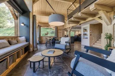 a living room with a couch and a table at Chalet Castor in Les Houches