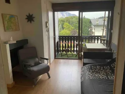 a living room with a view of a balcony at Studio très lumineux 4 pers in Les Carroz d'Araches