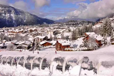 a town covered in snow with houses and buildings at Studio très lumineux 4 pers in Les Carroz d'Araches