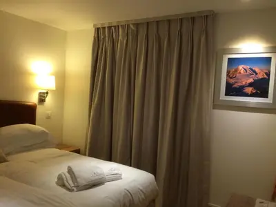 a hotel room with a bed and a window at Chalet Oryx in Chamonix-Mont-Blanc