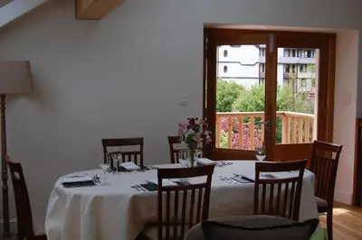 a dining room with a table with chairs and a window at Chalet Oryx in Chamonix-Mont-Blanc