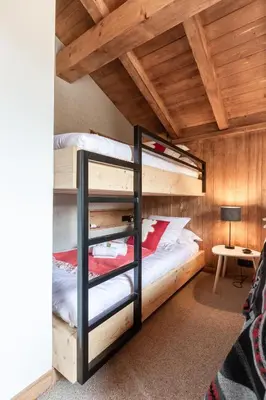 a bedroom with two bunk beds in a cabin at Megève - Chalet Miage in Demi-Quartier