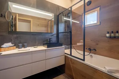 a bathroom with a shower and a sink and a tub at Chalet Ango I Jacuzzi & Hammam I Proche télécabine in Combloux