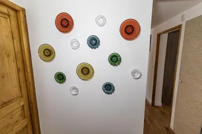 a wall with plates on a white wall at Megeve centre ville in Megève