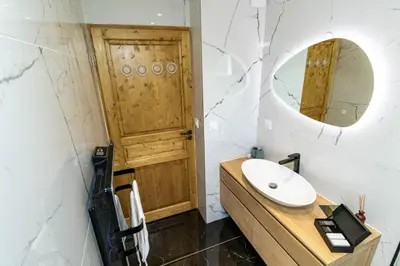 a bathroom with a sink and a mirror at Megeve centre ville in Megève