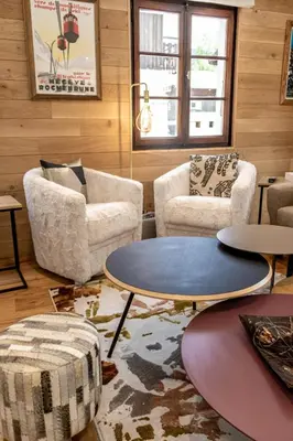 a living room with two chairs and a table at Megeve centre ville in Megève