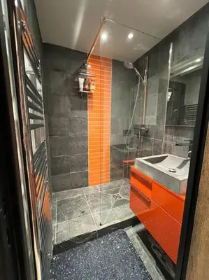 a kitchen with wooden cabinets and a sink and a stove at Appartement chaleureux Megève in Demi-Quartier
