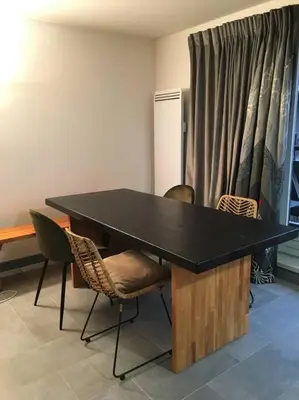 a black table and chairs in a room at Lyret - Centre ville, vue MontBlanc, parking, wifi in Chamonix-Mont-Blanc