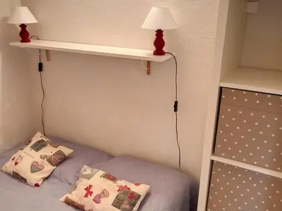 a bedroom with a bed with two pillows and a shelf at Studio confortable · 4 personnes · Flaine Centre · Terrasse - FR-1-425-204 in Arâches-la-Frasse