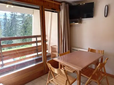a dining room with a table and chairs and a window at Studio confortable · 4 personnes · Flaine Centre · Terrasse - FR-1-425-204 in Arâches-la-Frasse