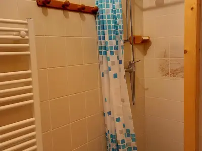 a bathroom with a shower with blue and white tiles at Studio confortable · 4 personnes · Flaine Centre · Terrasse - FR-1-425-204 in Arâches-la-Frasse