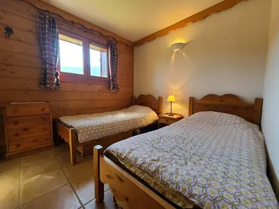 a bedroom with two beds and a window at Appartement 3 pièces cosy, 6 personnes, près de la piscine et du ski bus, parking inclus. - FR-1-572-285 in Arâches-la-Frasse