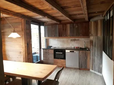 a kitchen with wooden walls and a wooden table at Appartement 4 pièces pour 7 pers. à Morillon, proche pistes - FR-1-815-94 in Morillon