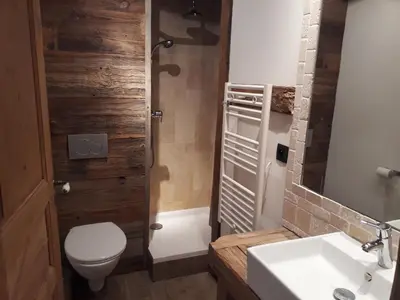 a living room with a flat screen tv in a cabin at Appartement 4 pièces pour 7 pers. à Morillon, proche pistes - FR-1-815-94 in Morillon