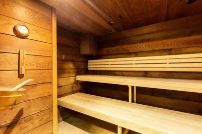 a sauna with wooden walls and wooden shelves at Résidence Les Fermes du Soleil - maeva Home - Appartement 3 Pièces 6 Personnes - Sélection MAE-6505 in Les Carroz d'Araches