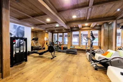 a gym with treadmills and exercise equipment in a room at Résidence Les Fermes du Soleil - maeva Home - Appartement 3 Pièces 6 Personnes - Sélection MAE-6505 in Les Carroz d'Araches