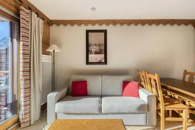 a living room with a couch and a table at Résidence Les Fermes du Soleil - maeva Home - Appartement 3 Pièces 6 Personnes - Sélection MAE-6505 in Les Carroz d'Araches