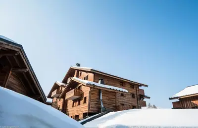 an old wooden building covered in snow at Résidence Les Fermes du Soleil - maeva Home - Appartement 3 pièces 6 Personnes - Sélection MAE-1535 in Les Carroz d'Araches