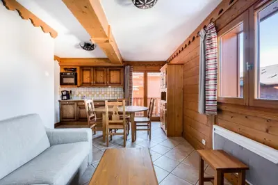 a living room with a couch and a table at Résidence Les Fermes du Soleil - maeva Home - Appartement 3 pièces 6 Personnes - Sélection MAE-1535 in Les Carroz d'Araches