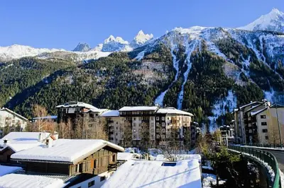 a city with snow covered mountains in the background at Résidence La Rivière - maeva Home - Appartement 2 pièces 6 personnes - Sélection MAE-8671 in Chamonix-Mont-Blanc