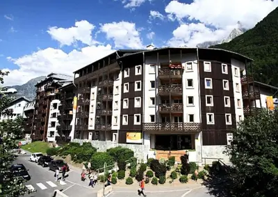 a large building with people walking in front of it at Résidence La Rivière - maeva Home - Appartement 2 pièces 6 personnes - Sélection MAE-8671 in Chamonix-Mont-Blanc