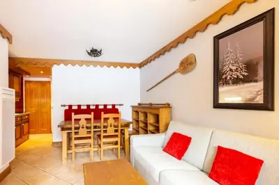 a living room with a couch and a table at Résidence Les Fermes du Soleil - maeva Home - Appartement 3 pièces 6 personnes - Sélection MAE-8004 in Les Carroz d'Araches