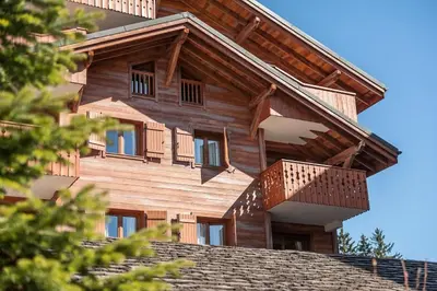 a wooden house with a balcony on top of a roof at Résidence Les Fermes du Soleil - maeva Home - Appartement 3 pièces 6 personnes - Sélection MAE-8004 in Les Carroz d'Araches
