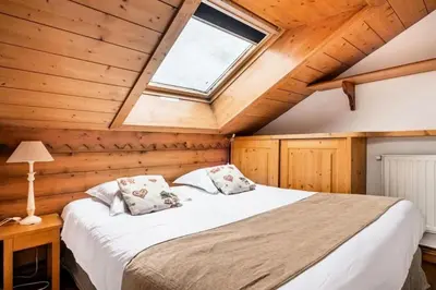 a bedroom with a large bed with a window at Résidence La Ginabelle - maeva Home - Appartement 2 Pièces 4 Personnes - Sélection MAE-9584 in Chamonix-Mont-Blanc