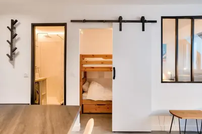 a room with a bunk bed and a door leading to a bedroom at L'Aiguille - maeva Home - 2 Pièces 4 Personnes Prestige MAE-0414 in Chamonix-Mont-Blanc