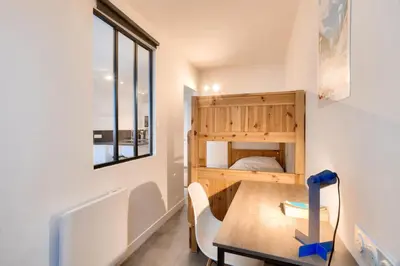 a small room with a table and a bed at L'Aiguille - maeva Home - 2 Pièces 4 Personnes Prestige MAE-0414 in Chamonix-Mont-Blanc