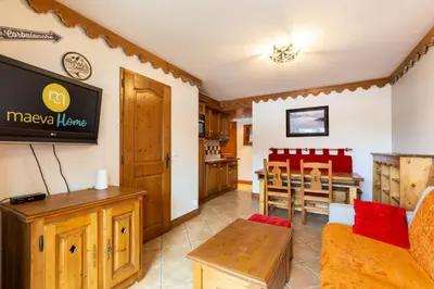 a living room with a tv and a dining room at Résidence Les Fermes du Soleil - maeva Home - Appartement 3 pièces 6 personnes - Sélection MAE-8007 in Les Carroz d'Araches