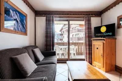 a living room with a couch and a table at Résidence La Ginabelle - maeva Home - Appartement 3 Pièces 6 Personnes - Prestige MAE-2304 in Chamonix-Mont-Blanc