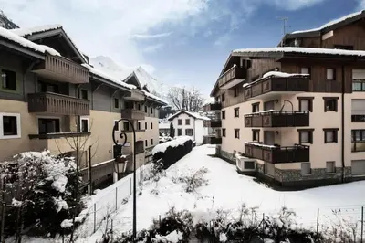a snow covered street in a town with buildings at Résidence La Ginabelle - maeva Home - Appartement 3 Pièces 6 Personnes - Prestige MAE-2304 in Chamonix-Mont-Blanc