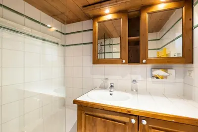 a bathroom with a sink and a shower at Résidence La Ginabelle - maeva Home - Appartement 3 Pièces 6 Personnes - Prestige MAE-2304 in Chamonix-Mont-Blanc