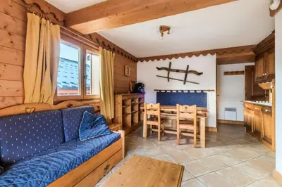 a living room with a couch and a table at Résidence Les Fermes du Soleil - maeva Home - 3 Pièces 6 Personnes Sélection MAE-4102 in Les Carroz d'Araches