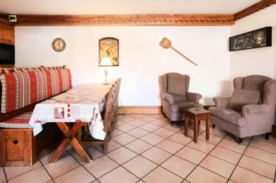 a living room with a table and two chairs at Résidence La Ginabelle - maeva Home - 4 Pièces 6 Personnes Sélection MAE-5671 in Chamonix-Mont-Blanc