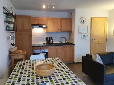 a kitchen and a table with a bowl on it at Le Clos B11 - 3 bedroom apartment 5 minutes walk to the square in Samoëns