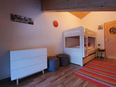 a bedroom with a white cabinet and two trash cans at Le Clos B11 - 3 bedroom apartment 5 minutes walk to the square in Samoëns