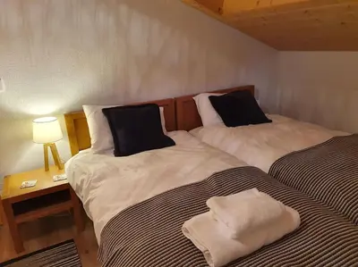 two beds sitting next to each other in a room at Le Clos B11 - 3 bedroom apartment 5 minutes walk to the square in Samoëns