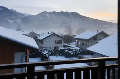 a snow covered town with houses and mountains at Le Clos B11 - 3 bedroom apartment 5 minutes walk to the square in Samoëns