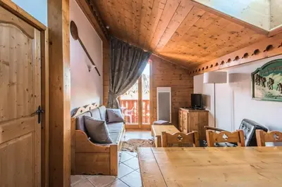 a living room with a table and chairs at Résidence Les Fermes du Soleil - maeva Home - Appartement 4 pièces 7 personnes Selection MAE-0493 in Les Carroz d'Araches