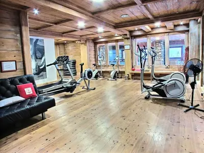 a gym with several treadmills and exercise bikes at Résidence Les Fermes du Soleil - maeva Home - Appartement 3 pièces 6 personnes Sélection MAE-1439 in Les Carroz d'Araches